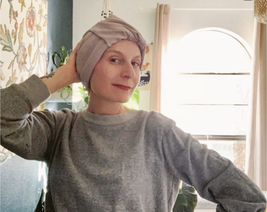 A customer adjusting her blush headwrap