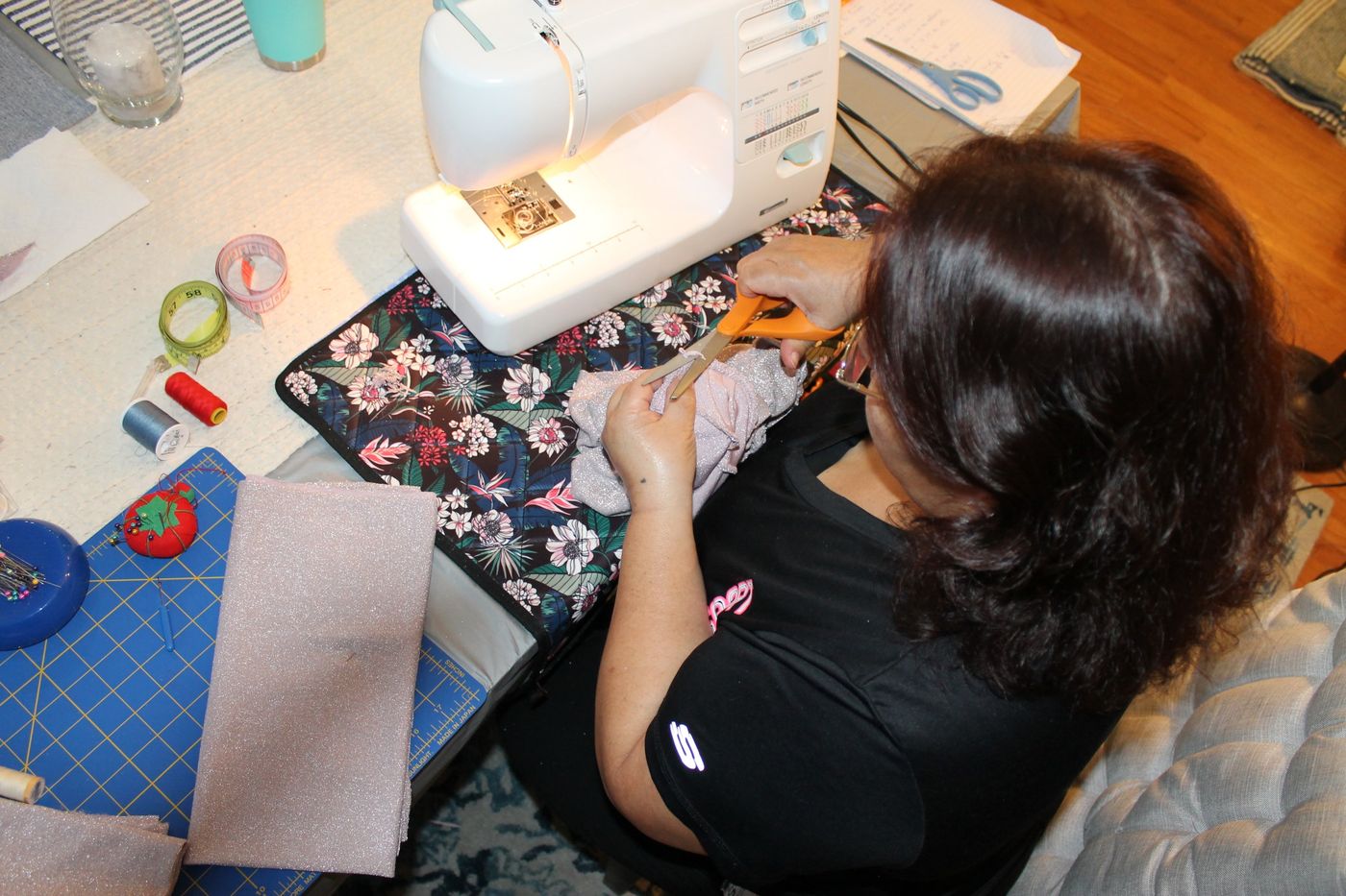 Natalie's mom sewing a blush headwrap at her sewing machine